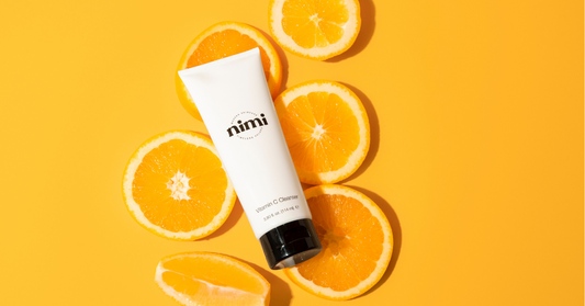 Nimi's Vitamin C Cleanser on top of sliced oranges 